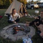 friends enjoying marshmallow on campfire
